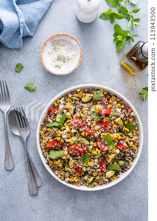 Warm quinoa salad with tomatoes, corn and zucchini Warm quinoa salad with tomatoes, corn and zucchini 113943500