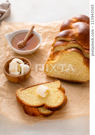 Freshly baked hallah sliced with butter and honey Freshly baked hallah sliced with butter and honey 113943505