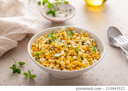 Sauteed yellow and white corn with herbs, healthy side dish idea 113943521
