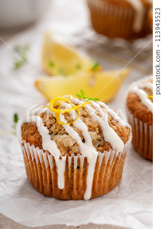 Lemon zucchini muffins with thyme and cream cheese glaze 113943523