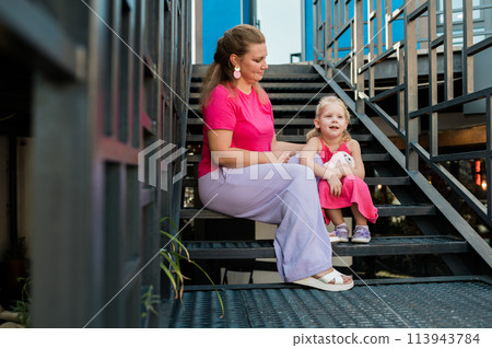 Mother holds and have fun her child with hearing aids and cochlear implants summer outdoor . Deaf and health concept. Diversity and Inclusion and people with disability concept. Copy space 113943784