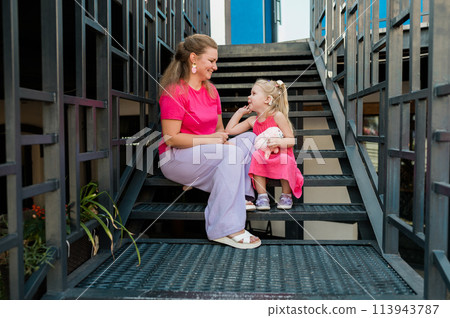 Mother holds and have fun her child with hearing aids and cochlear implants summer outdoor . Deaf and health concept. Diversity and Inclusion and people with disability concept. Copy space 113943787