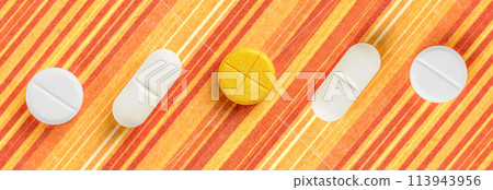 Pills and medicines arranged on an orange striped background. It's a visual representation of pharmaceuticals Pills and medicines arranged on an orange striped background. It's a visual representation of pharmaceuticals 113943956