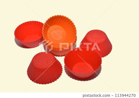 Red rubber molds for baking cupcakes. 113944270