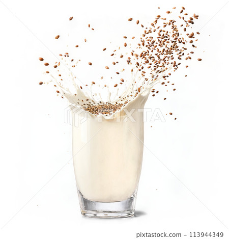 Flax milk splash nutty and creamy splashing out of a glass with whole flax seeds 113944349