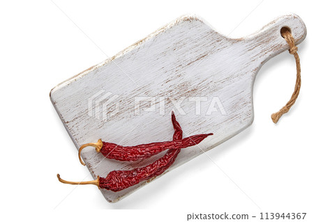 White wooden cutting board and two dried capsicums isolated on a white background. Top view with copy space White wooden cutting board and two dried capsicums isolated on a white background. Top view with copy space 113944367