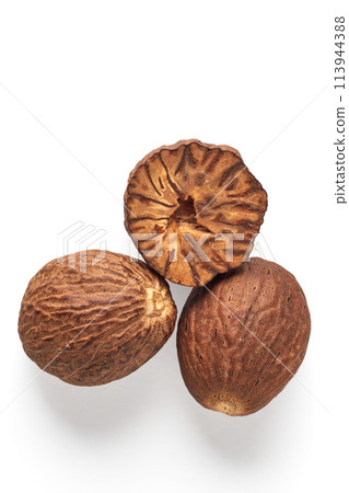 Three textured nutmegs isolated on a white background. Spices for cooking Three textured nutmegs isolated on a white background. Spices for cooking 113944388