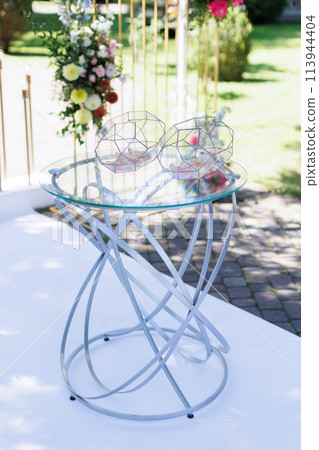 Glass top table with flowers in wedding Glass top table with flowers in wedding 113944404