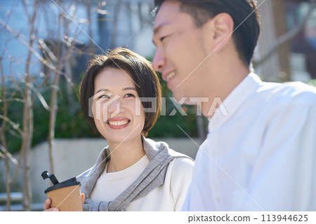 Man and woman having an intimate conversation outdoors Man and woman having an intimate conversation outdoors 113944625