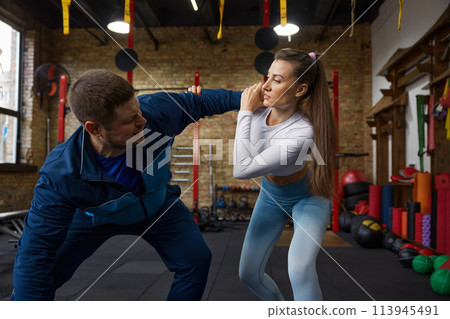 Young man and woman couple training indoors at sport studio 113945491