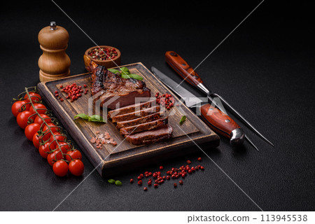Delicious juicy beef steak on the bone, tomahawk with salt, spices and herbs 113945538