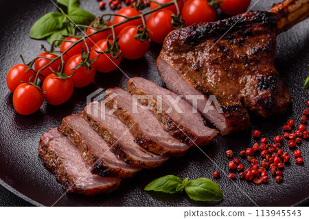 Delicious juicy beef steak on the bone, tomahawk with salt, spices and herbs 113945543