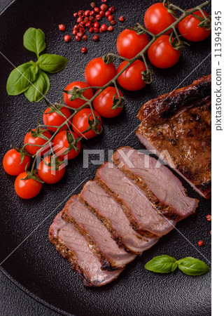 Delicious juicy beef steak on the bone, tomahawk with salt, spices and herbs Delicious juicy beef steak on the bone, tomahawk with salt, spices and herbs 113945545