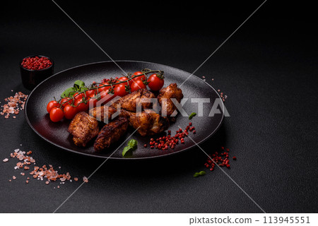 Delicious juicy chicken wings baked on the grill with salt, spices and herbs Delicious juicy chicken wings baked on the grill with salt, spices and herbs 113945551
