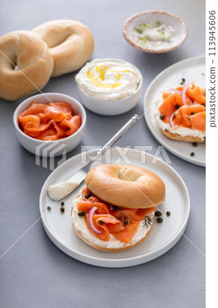 Plain bagel with salmon and cream cheese with fresh dill and capers 113945606