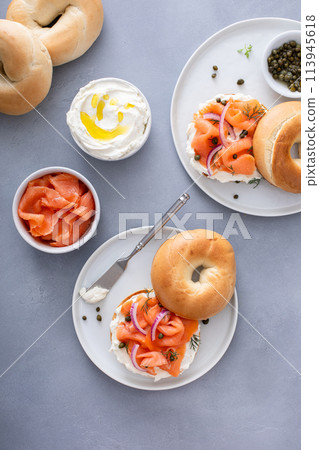 Plain bagel with salmon and cream cheese with fresh dill and capers 113945618