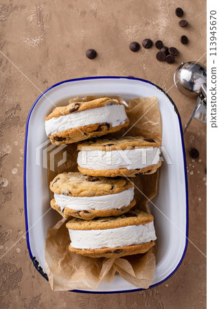 Ice cream sandwiches with vanilla ice cream and chocolate chip cookies 113945670