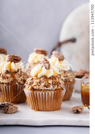 Caramel pecan cupcakes with cream cheese frosting Caramel pecan cupcakes with cream cheese frosting 113945700