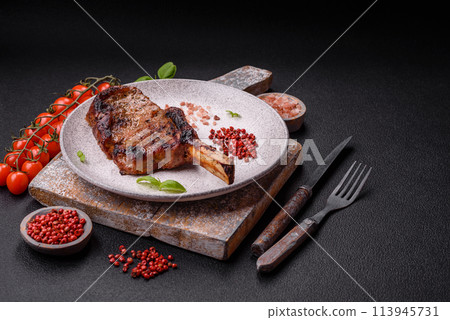 Delicious juicy beef steak on the bone, tomahawk with salt, spices and herbs 113945731