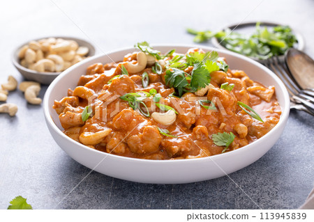 Traditional thai chicken curry with cashews and herbs Traditional thai chicken curry with cashews and herbs 113945839