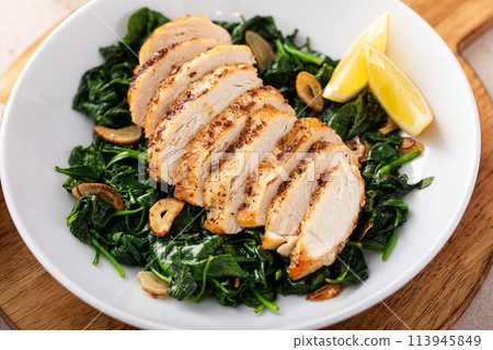 Grilled chicken with sauteed spinach, healthy dinner idea 113945849