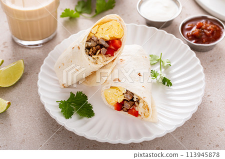 Breakfast burritos with scrambled eggs, sausage, cheese and potatoes 113945878