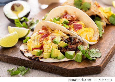 Breakfast tacos with sausage, eggs, bacon and avocado Breakfast tacos with sausage, eggs, bacon and avocado 113945884