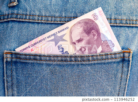Banknote of five turkish lira sticking out of the jeans pocket Banknote of five turkish lira sticking out of the jeans pocket 113946252