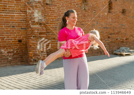 Child girl with cochlear implant with her mother spend time outdoor. Hear impairment and deaf community concept. Deaf and health concept. Disability and inclusion. Copy space 113946649