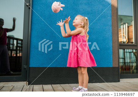 Child with hearing problem and cochlear implant dance in street, deaf kid began to hear. Hearing loss in childhood and treatment concept. Copy space and empty place for text. Inclusion and disability 113946697