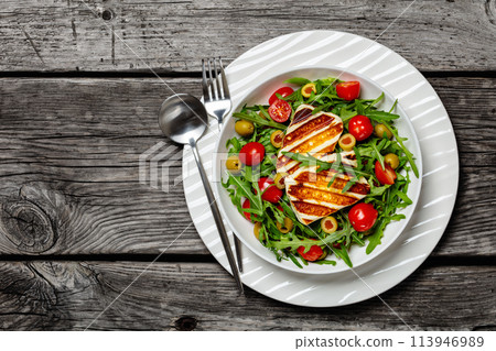 salad with grilled halloumi greek cheese in bowl 113946989