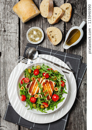 salad with grilled halloumi greek cheese in bowl 113946990