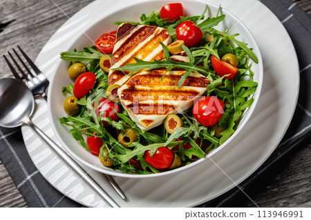 salad with grilled halloumi greek cheese in bowl 113946991