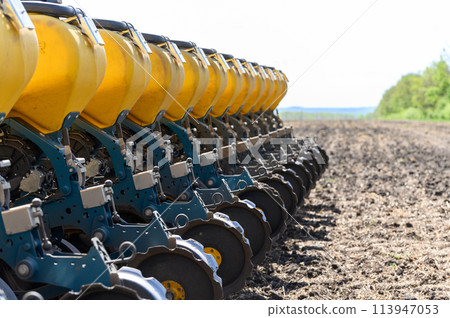 A tractor sows a field with grain. A tractor sows a field with grain. 113947053