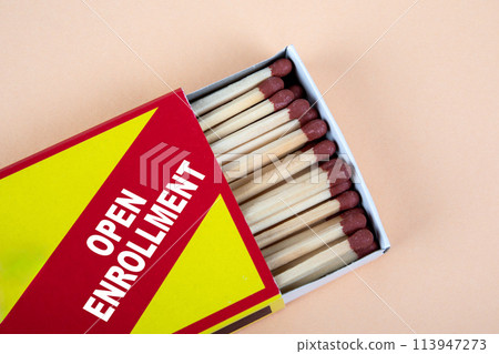 OPEN ENROLLMENT. Open matchbox on a light background OPEN ENROLLMENT. Open matchbox on a light background 113947273