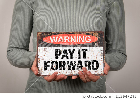 Pay It Forward. Warning sign with text woman in hand Pay It Forward. Warning sign with text woman in hand 113947285