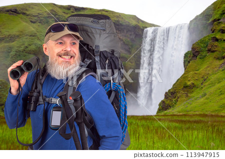 bearded man traveler with tourist equipment and binoculars in hand  113947915