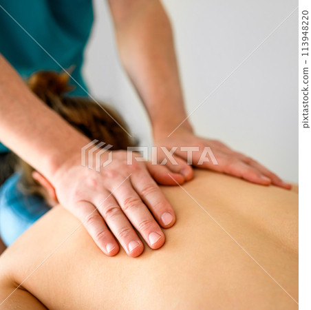 Girl during massage for neck and shoulders in spa clinic salon. Masseur hands doing care body therapy procedure for young woman wellness and relaxation. Girl during massage for neck and shoulders in spa clinic salon. Masseur hands doing care body therapy procedure for young woman wellness and relaxation. 113948220