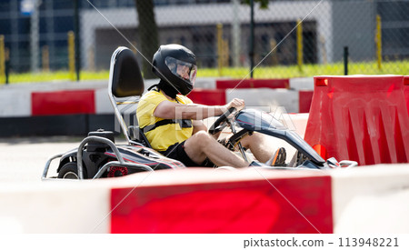 Man In Protective Helmet Driving Go-Kart By Extreme Entettainment Racing Track Man In Protective Helmet Driving Go-Kart By Extreme Entettainment Racing Track 113948221