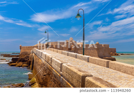 Fort San Sebastian and the stone breakwater bridge leading to it on a sunny day. Fort San Sebastian and the stone breakwater bridge leading to it on a sunny day. 113948260