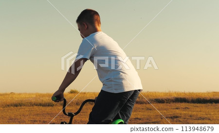 child boy son teenager rides bicycle, child boy pedals bicycle, children ride bicycle park sunset, learn ride bicycle, happy family, child, son rides sunset, spin steering wheel, boy son dream, family child boy son teenager rides bicycle, child boy pedals bicycle, children ride bicycle park sunset, learn ride bicycle, happy family, child, son rides sunset, spin steering wheel, boy son dream, family 113948679