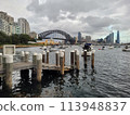 Sydney's harbour foreshore set against the famous Sydney Harbour bridge on a cloudy overcast day Sydney's harbour foreshore set against the famous Sydney Harbour bridge on a cloudy overcast day 113948837