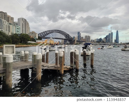Sydney's harbour foreshore set against the famous Sydney Harbour bridge on a cloudy overcast day 113948837