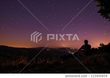 Man Contemplating Starry Sky at Twilight 113950854