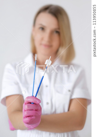 Close-up of gynecological instruments for taking a cytological smear from the cervical canal of the cervix 113950855