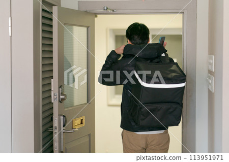 Back view of a man carrying a delivery bag Back view of a man carrying a delivery bag 113951971