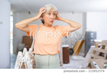 Woman dissatisfied with result of repair works Woman dissatisfied with result of repair works 113952574