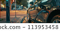 close-up image of electric vehicle charging station with a charging cable plugged into a car 113953458