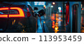 close-up image of electric vehicle charging station with a charging cable plugged into a car 113953459