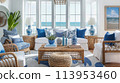 coastal-inspired living room with nautical decor, blue and white color palette, and natural textures such as rattan and driftwood. featuring panoramic views of the ocean through floor-to-ceiling 113953460